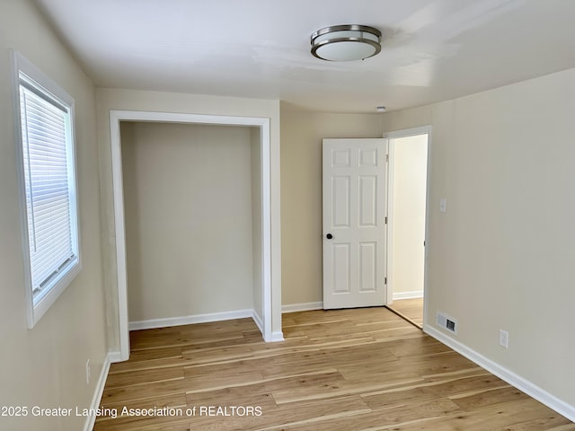 218 S Hayford Ave, Lansing, MI 48912 - unfurnished bedroom featuring light wood-type flooring, baseboards, and a closet