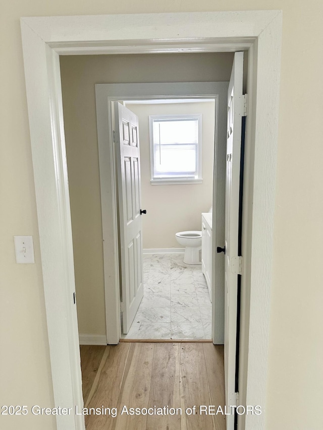 218 S Hayford Ave, Lansing, MI 48912 - bathroom with toilet, marble look tiles, baseboards, and vanity