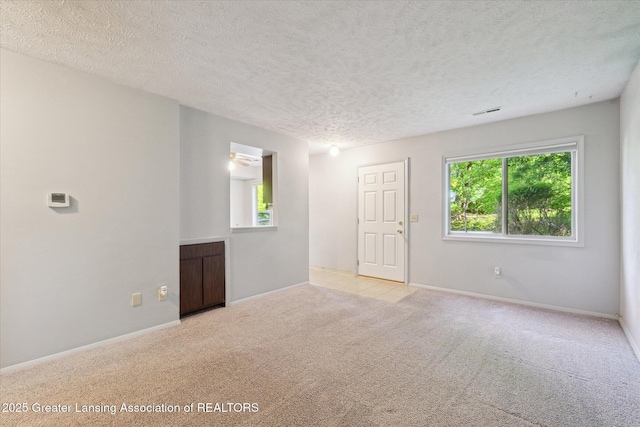 820 Kenwood Ave, Lansing, MI 48910 - carpeted empty room with a textured ceiling and baseboards