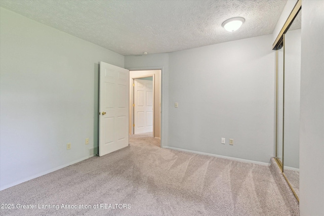 820 Kenwood Ave, Lansing, MI 48910 - unfurnished room with carpet, a textured ceiling, and baseboards