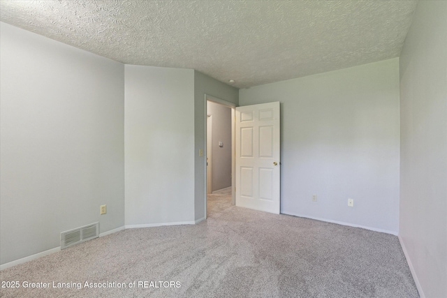 820 Kenwood Ave, Lansing, MI 48910 - carpeted empty room with a textured ceiling and baseboards
