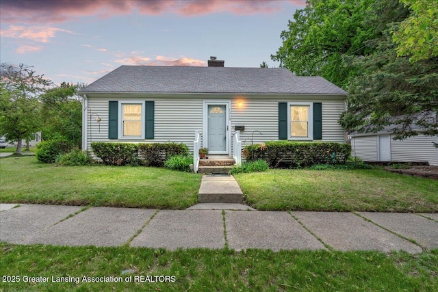 1218 Woodbine Ave, Lansing, MI 48910 - view of front of property featuring a front lawn and a chimney