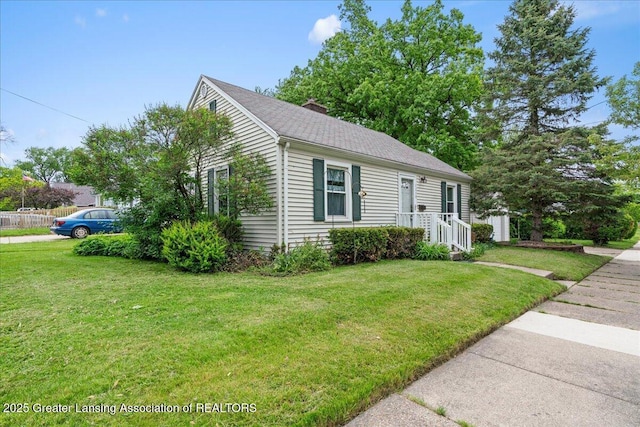 1218 Woodbine Ave, Lansing, MI 48910 - view of front of house featuring a chimney and a front yard