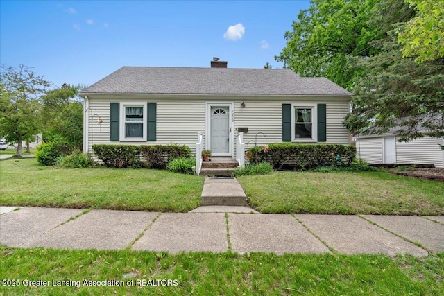 1218 Woodbine Ave, Lansing, MI 48910 - view of front of house featuring a front lawn and a chimney