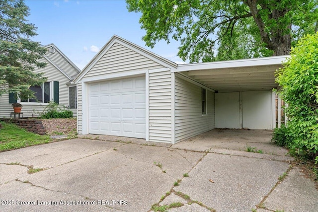 1218 Woodbine Ave, Lansing, MI 48910 - garage with concrete driveway and a garage