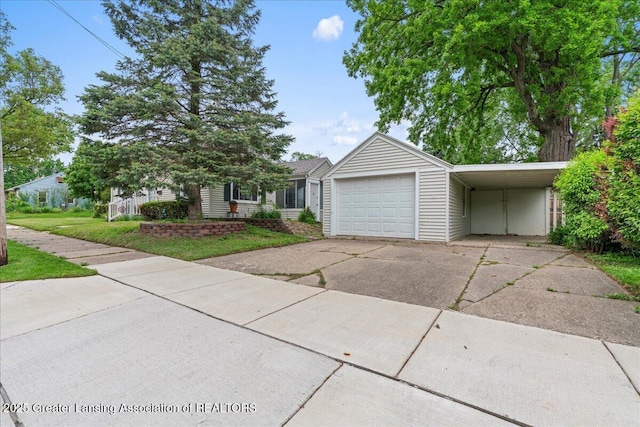 1218 Woodbine Ave, Lansing, MI 48910 - view of front of property featuring driveway and a garage