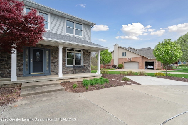 549 Riverwalk Dr, Mason, MI 48854 - view of front of house with a porch and stone siding