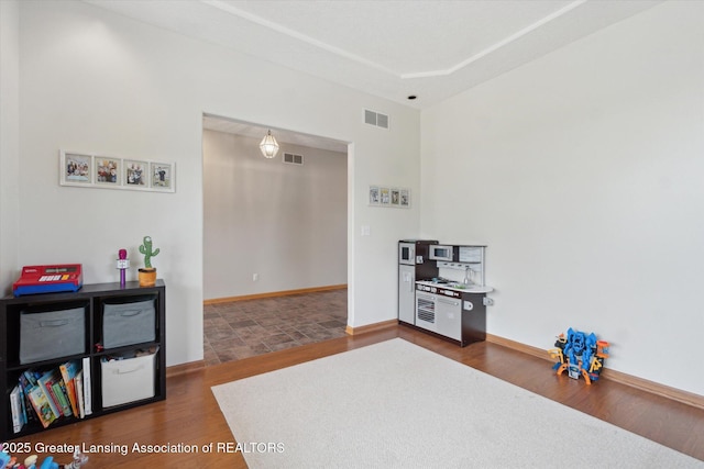 549 Riverwalk Dr, Mason, MI 48854 - recreation room with wood finished floors and baseboards