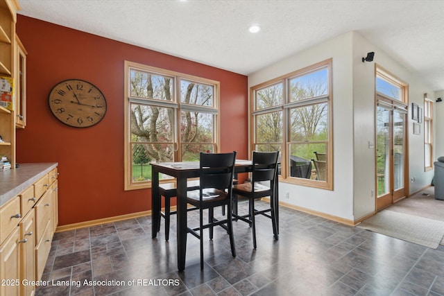 549 Riverwalk Dr, Mason, MI 48854 - dining space featuring baseboards, healthy amount of natural light, a textured ceiling, stone finish floors, and recessed lighting