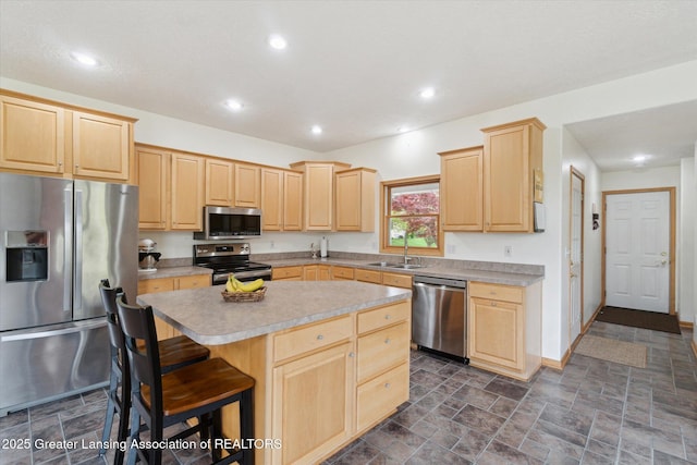 549 Riverwalk Dr, Mason, MI 48854 - kitchen with stainless steel appliances, light brown cabinets, a sink, a kitchen island, and light countertops