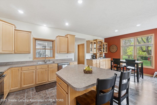 549 Riverwalk Dr, Mason, MI 48854 - kitchen featuring a sink, light brown cabinets, a center island, a breakfast bar, and dishwasher