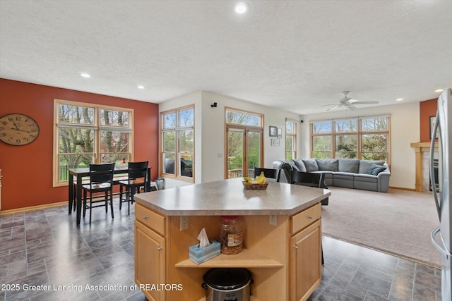 549 Riverwalk Dr, Mason, MI 48854 - kitchen with a textured ceiling, a kitchen island, baseboards, recessed lighting, and open shelves