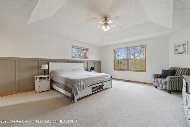 549 Riverwalk Dr, Mason, MI 48854 - carpeted bedroom with a raised ceiling, a textured ceiling, and a ceiling fan