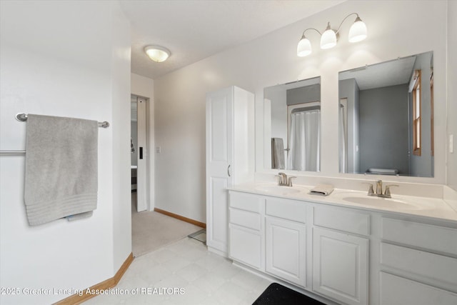 549 Riverwalk Dr, Mason, MI 48854 - bathroom with double vanity, toilet, baseboards, and tile patterned floors