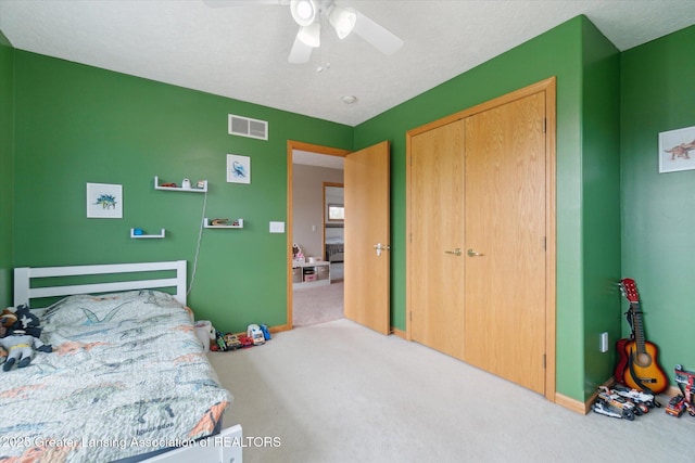549 Riverwalk Dr, Mason, MI 48854 - carpeted bedroom featuring a ceiling fan, a closet, and baseboards