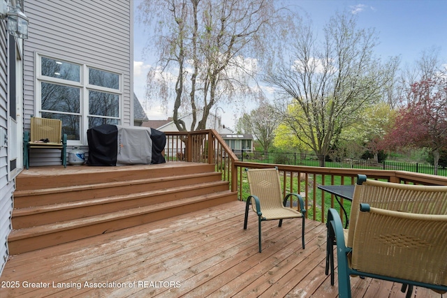 549 Riverwalk Dr, Mason, MI 48854 - deck with area for grilling and a fenced backyard