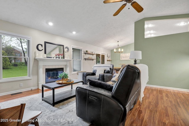 722 Fieldview Dr, Grand Ledge, MI 48837 - living area with light wood-type flooring, baseboards, a fireplace, ceiling fan, and vaulted ceiling
