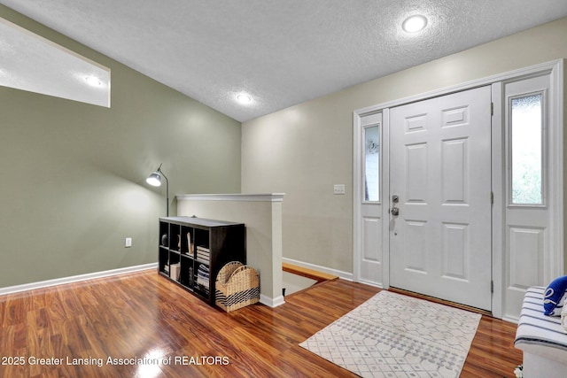 722 Fieldview Dr, Grand Ledge, MI 48837 - foyer with a textured ceiling, wood finished floors, and baseboards