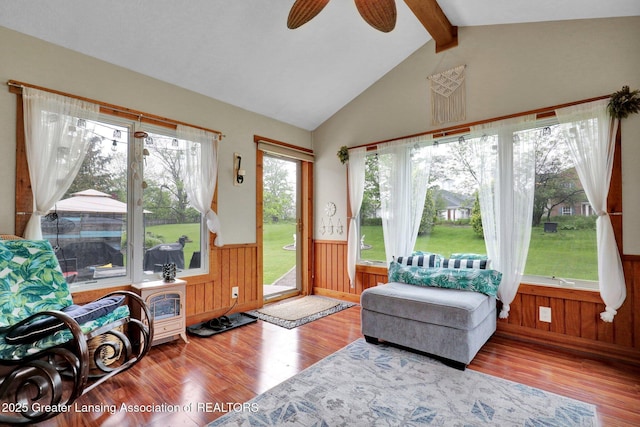 722 Fieldview Dr, Grand Ledge, MI 48837 - living area with wainscoting, wood finished floors, wood walls, and ceiling fan