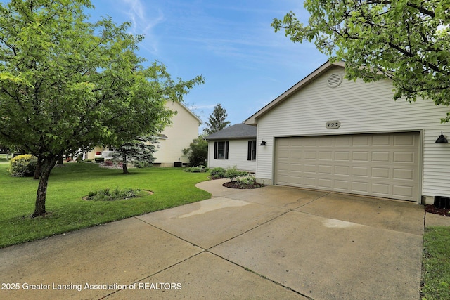 722 Fieldview Dr, Grand Ledge, MI 48837 - view of front of house featuring a front lawn, a garage, and driveway