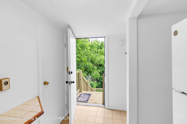 316 S Rosemary Ave, Lansing, MI 48917 - doorway with a textured ceiling, light tile patterned flooring, and a wall of windows