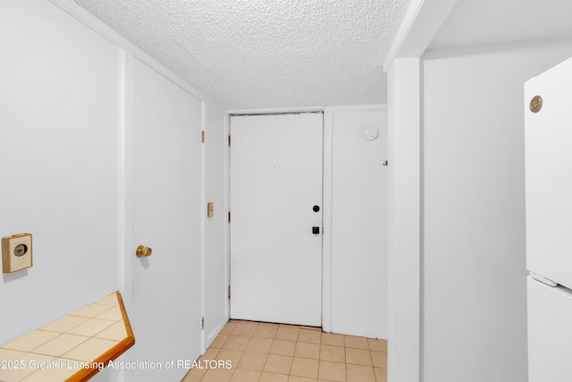 316 S Rosemary Ave, Lansing, MI 48917 - hall featuring a textured ceiling and light tile patterned floors