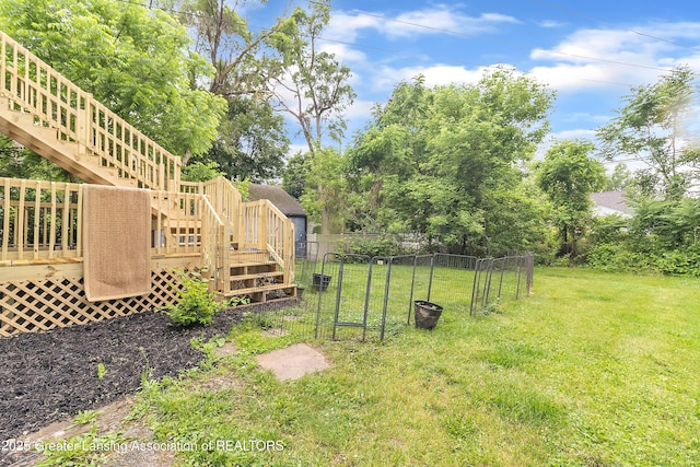 316 S Rosemary Ave, Lansing, MI 48917 - view of yard with stairway, a wooden deck, and view of scattered trees