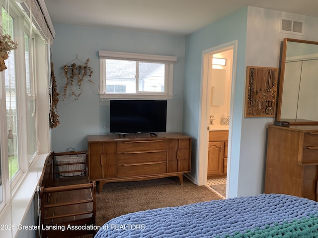 575 Brookland Blvd, Lansing, MI 48910 - carpeted bedroom featuring ensuite bathroom