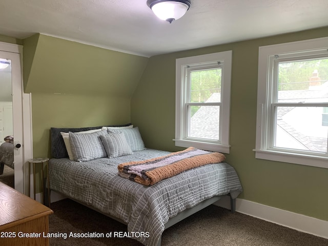 575 Brookland Blvd, Lansing, MI 48910 - carpeted bedroom with multiple windows, vaulted ceiling, and baseboards