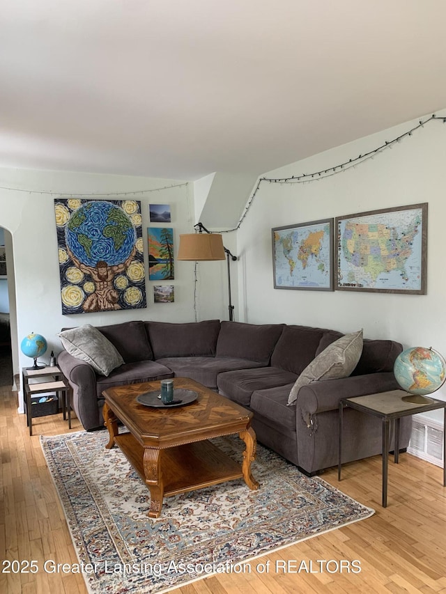 575 Brookland Blvd, Lansing, MI 48910 - living area with light wood-style flooring and arched walkways