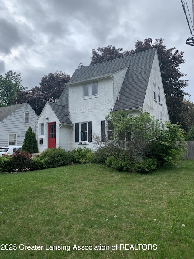 575 Brookland Blvd, Lansing, MI 48910 - view of front facade with a front yard and a shingled roof