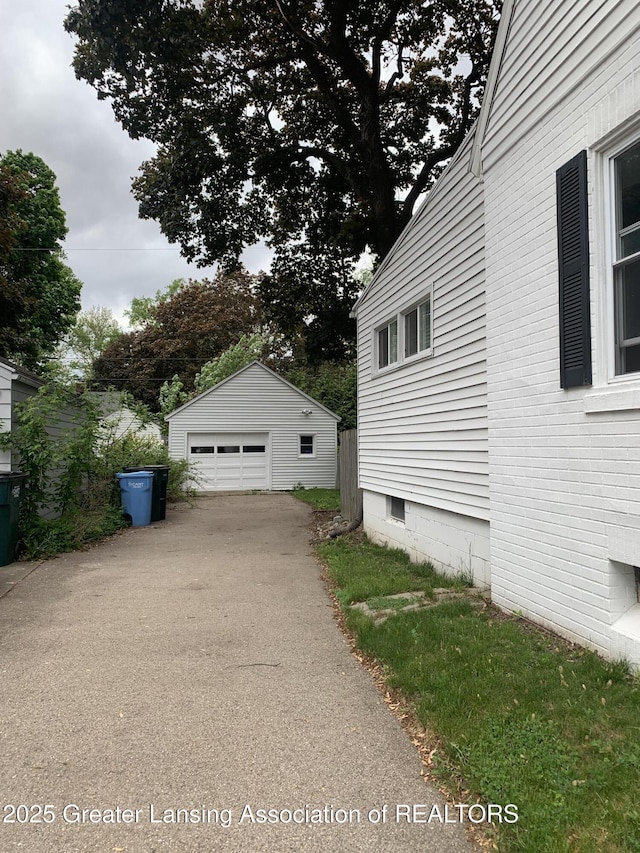 575 Brookland Blvd, Lansing, MI 48910 - view of home's exterior with a garage, an outdoor structure, and driveway