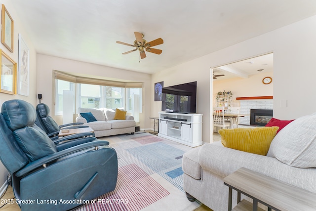 2305 Post Oak Ln, Lansing, MI 48912 - living area featuring ceiling fan, a fireplace, baseboards, and light wood-style floors