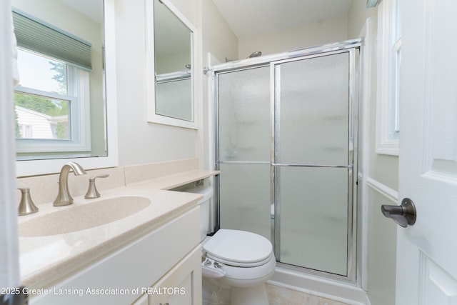 2305 Post Oak Ln, Lansing, MI 48912 - bathroom with vanity, a shower stall, and toilet