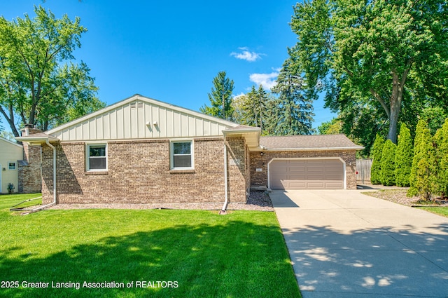 2305 Post Oak Ln, Lansing, MI 48912 - view of front facade with an attached garage, board and batten siding, concrete driveway, brick siding, and a front lawn