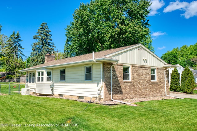 2305 Post Oak Ln, Lansing, MI 48912 - view of front facade featuring a chimney, central AC, and brick siding