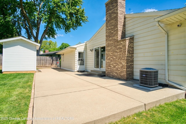2305 Post Oak Ln, Lansing, MI 48912 - view of patio featuring central AC and entry steps