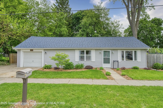 206 Okemos Rd, Mason, MI 48854 - single story home featuring roof with shingles, driveway, and an attached garage