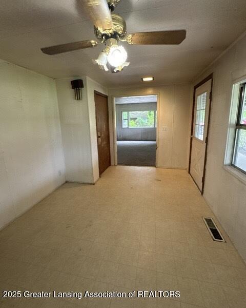 9882 W M 21, Ovid, MI 48866 - spare room with ceiling fan, healthy amount of natural light, and light flooring