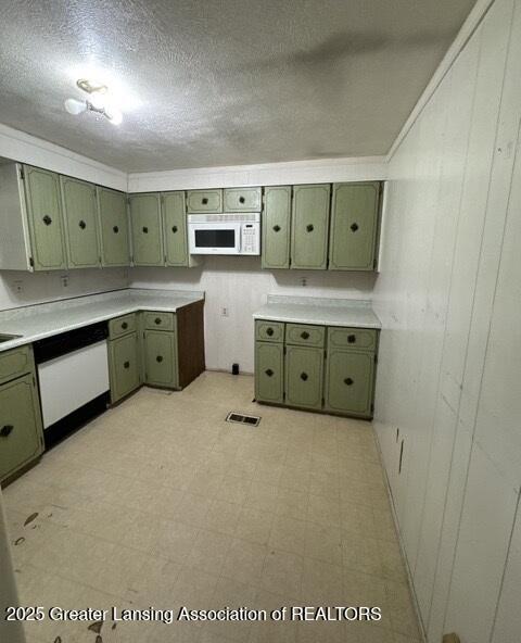 9882 W M 21, Ovid, MI 48866 - kitchen with green cabinets, white appliances, light floors, a textured ceiling, and light countertops
