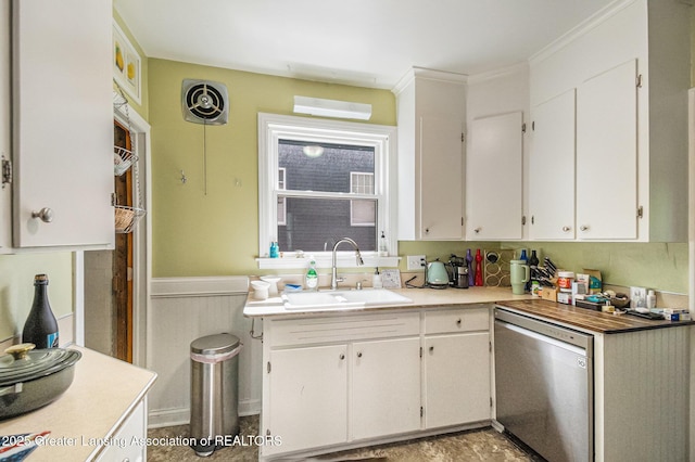 1417 W Ottawa St, Lansing, MI 48915 - kitchen featuring stainless steel dishwasher, a sink, white cabinetry, wainscoting, and light countertops