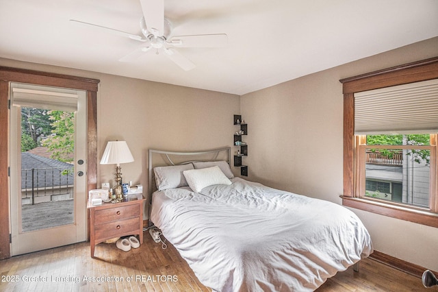 1417 W Ottawa St, Lansing, MI 48915 - bedroom with access to outside, wood finished floors, ceiling fan, and baseboards