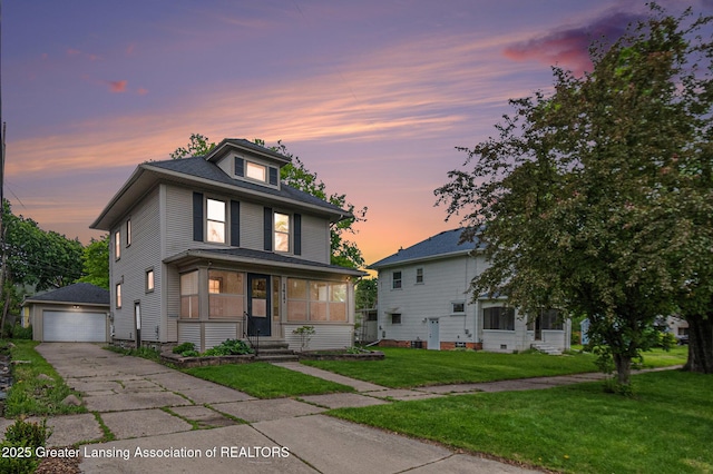 1417 W Ottawa St, Lansing, MI 48915 - american foursquare style home featuring an outdoor structure, a garage, a lawn, and entry steps
