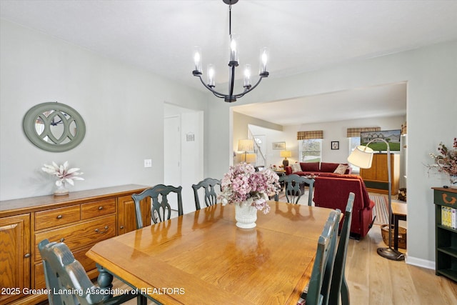 1990 S Waverly Rd, Eaton Rapids, MI 48827 - dining room featuring a chandelier and light wood-style floors
