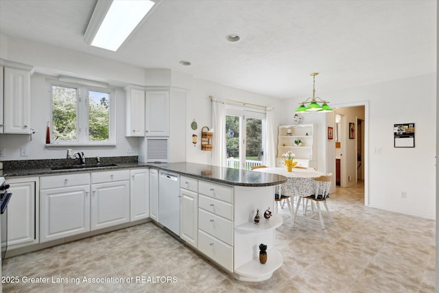 1990 S Waverly Rd, Eaton Rapids, MI 48827 - kitchen featuring a sink, stainless steel dishwasher, a peninsula, and plenty of natural light