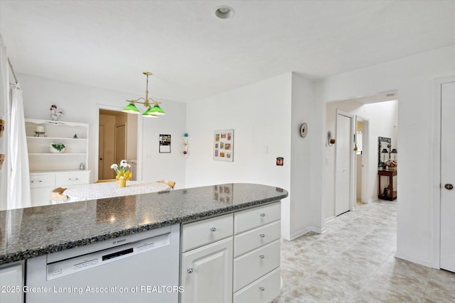 1990 S Waverly Rd, Eaton Rapids, MI 48827 - kitchen with dishwasher, white cabinets, dark stone counters, decorative light fixtures, and baseboards