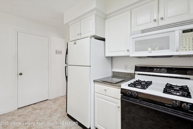1990 S Waverly Rd, Eaton Rapids, MI 48827 - kitchen with white appliances, white cabinetry, and dark stone counters