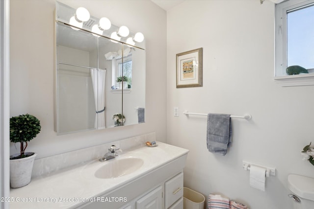 1990 S Waverly Rd, Eaton Rapids, MI 48827 - bathroom with vanity, toilet, and a shower with shower curtain