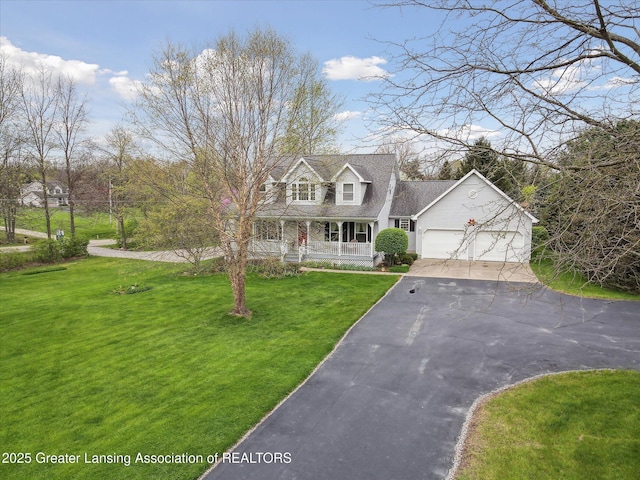 1990 S Waverly Rd, Eaton Rapids, MI 48827 - new england style home with asphalt driveway, covered porch, an attached garage, and a front yard