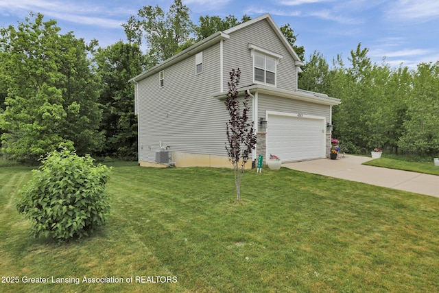 4269 Tamarack St, Holt, MI 48842 - view of home's exterior featuring concrete driveway, an attached garage, a lawn, and cooling unit